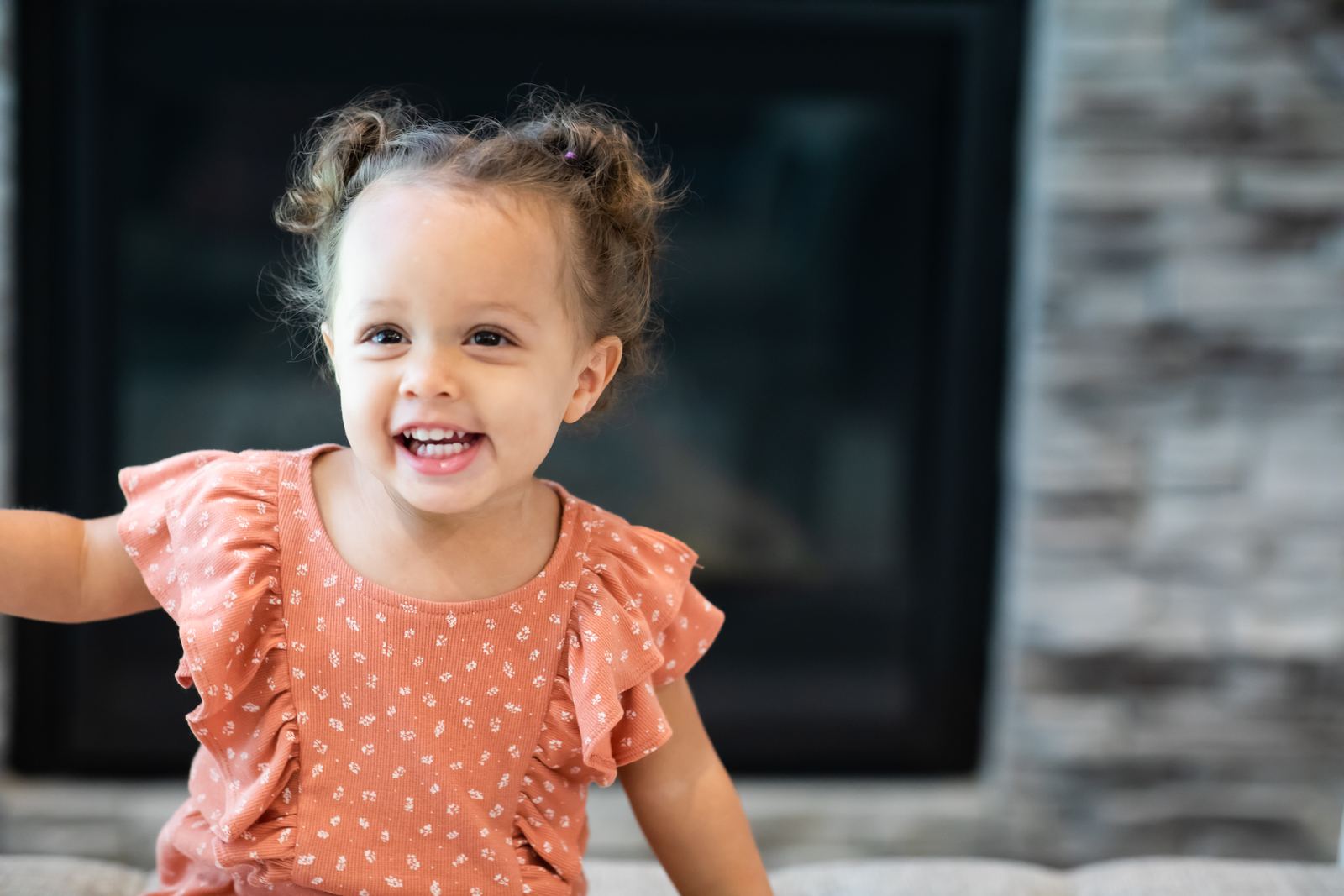 A toddler smiling in a living room